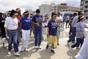 Archbishop Desmond Tutu leads protestors in a demonstration against the racially segregated beaches on Gordon’s Bay beach