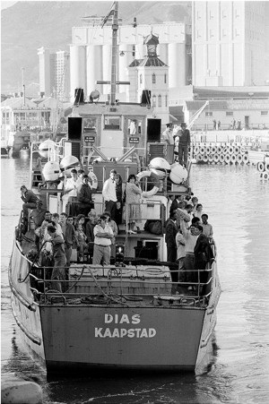 Accompanied by prison personnel, political prisoners on their release from Robben Island prison, in Cape Town Harbour