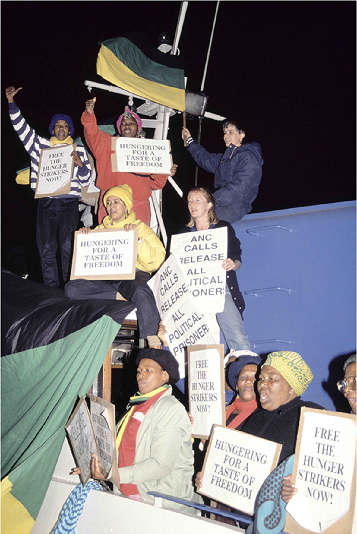 Relatives and supporters of the remaining Robben Island prisoners stage a demonstration on board a ferry to highlight the plight of hunger strikers on the island