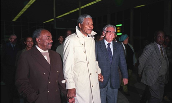 Nelson Mandela is flanked by Alfred Nzo and Joe Slovo at DF Malan Airport to welcome newly returned ANC and SACP exiles