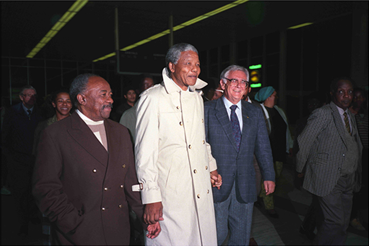 Nelson Mandela is flanked by Alfred Nzo and Joe Slovo at DF Malan Airport to welcome newly returned ANC and SACP exiles
