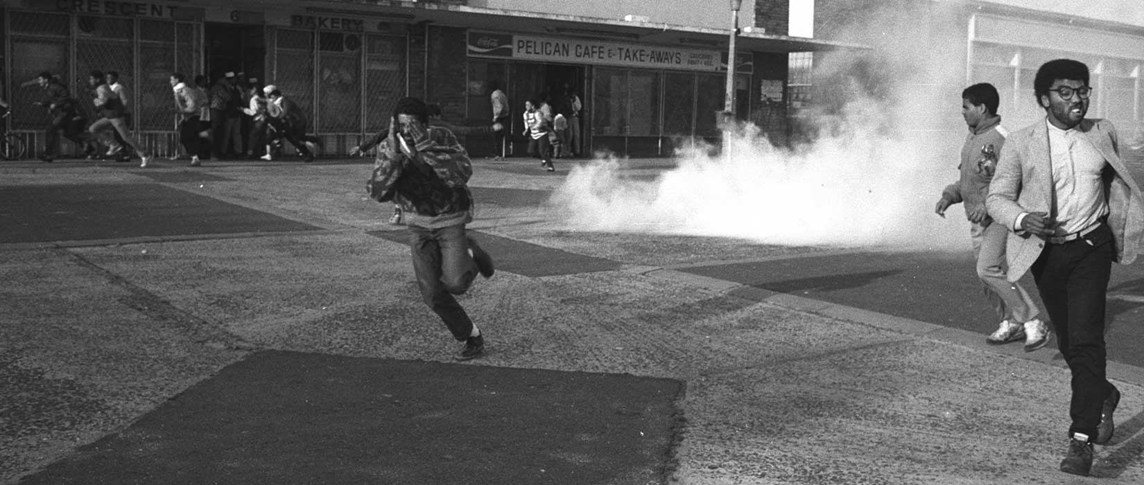 Police tear-gas Defiance Campaign meeting at the Bonteheuwel Civic Centre in 1989
